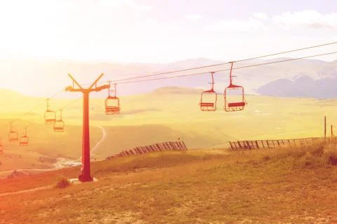 A view to red open cableway cabin over the top of the mountain and beautiful  Stock Photos