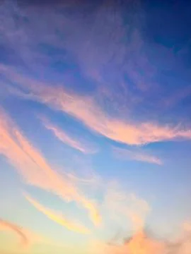 A view of reddish clouds as the sun rises over a dense urban area. Stock Photos