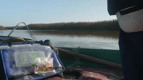 View of reeds and river surface from boat standing on river. Getting ready for Stock-Footage 124123286