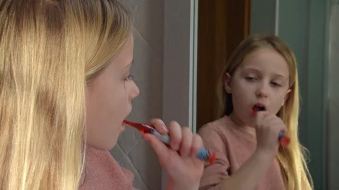 View of reflection if the mirror of a little cute fair-haired girl Stock Footage 126187527