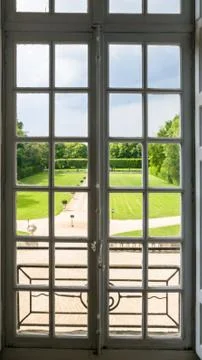View of the regular Park through a window with bars. Summer Stock Photos