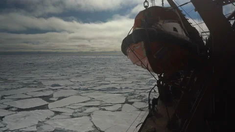 View of a rescue boat on a ship sailing through the ice. Ship sails through the Stock Footage 143673097