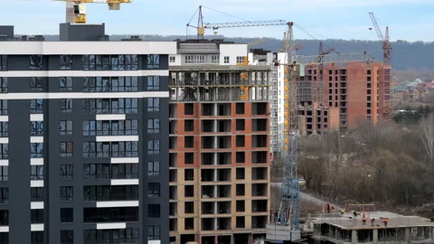 View of a residential building construction with cranes, employees do their job Stock Footage 148270962