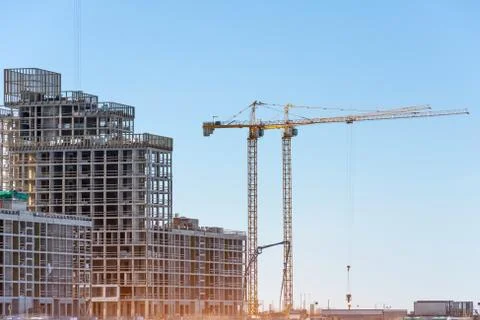 View of a residential complex under construction with high cranes. Large-scal 스톡 사진