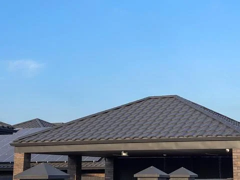 View of Residential Rooftops Under a Clear Blue Sky With Solar Panels on th.. Stock Photos