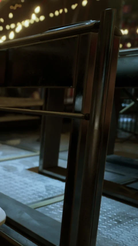 View of a restaurant table with a focus on the metal frame and floor design Stock Footage 341043228