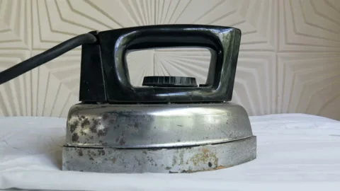 View of retro electrical iron on an ironing board Stock Footage 104299032