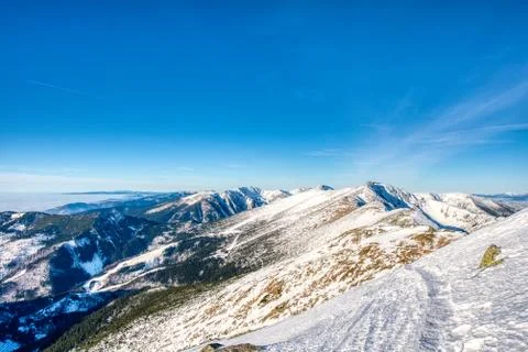 View of ridge in Low Tatras with highest mountains at sunrise in winter, Slov Stock Photos