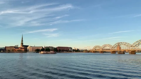 View of Riga city skyline from a moving boat. Another cruise boat sails in front Stock Footage 220458092