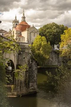 View of the river, ancient stone bridge and church in the city of Amarante .. Stock Photos