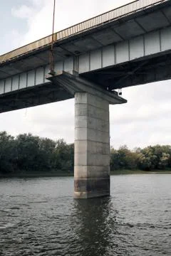 View of the river and constructions under the bridge. Stock Photos