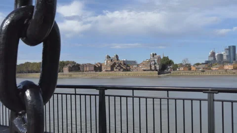 View of a river and distant buildings through a metal railing.  Stock Footage 345266154