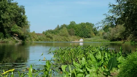 View of the river and the tent in the distance. Ideal country vacation in summer Stock Footage 283334645