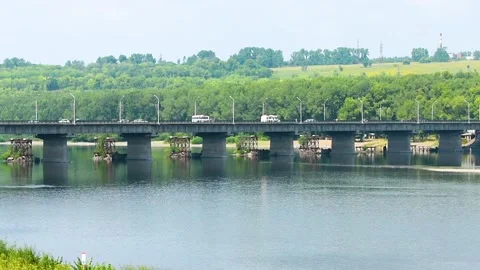 View of the river and the transport bridge over which cars move Stock Footage 139748577