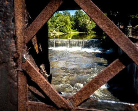 View of River and Waterfall Through Rusty Metal Fence Stock Photos