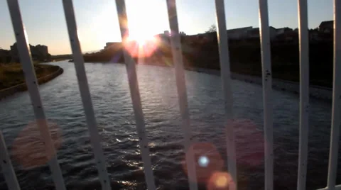 View of the river from the bridge through the fence 動画素材 37873708