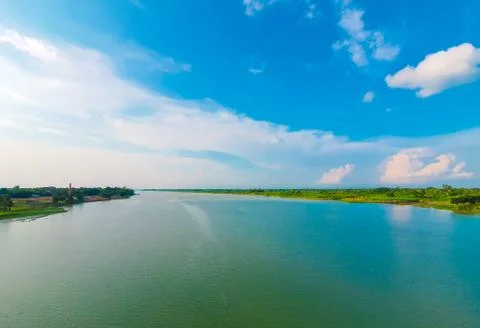 View of a river from the bridge with white clouds on the sky in Bangladesh. Stock Photos