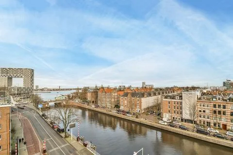 A view of the river with buildings on either side Stock Photos