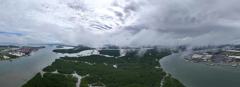 A view of a river with a cloudy sky in the background Stock Photos