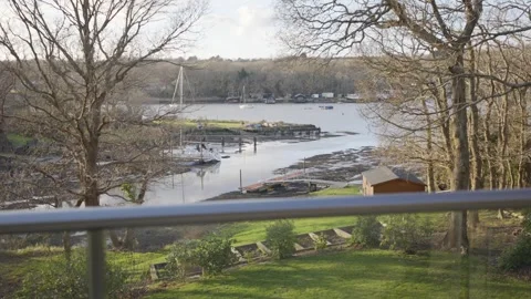 A view of a river with a dock and a small shed Video stock 302441924