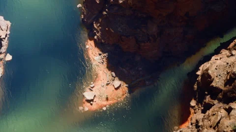 View of a river flowing through rocks in a canyon during daylight hours Video stock 344401521