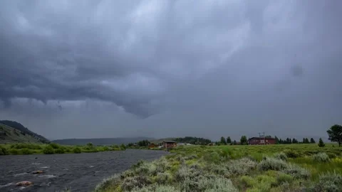 View of a river flowing under a dark stormy sky, United States. 스톡 동영상 344410696