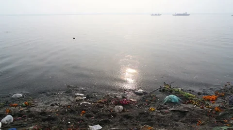 View on river Ganges and passing boats from the dirty shore. Stock Footage 50525275