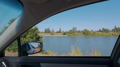 View of river from inside a car driving in slow motion Stock Footage 309599964