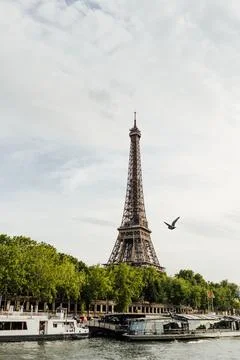 View of the river Seine and the Eiffel tower under a cloudy sky in Paris, France Stock Photos