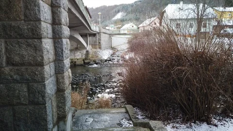 View at river with a tiny waterfall in the back, revealing a tunnel, and Video stock 124919144
