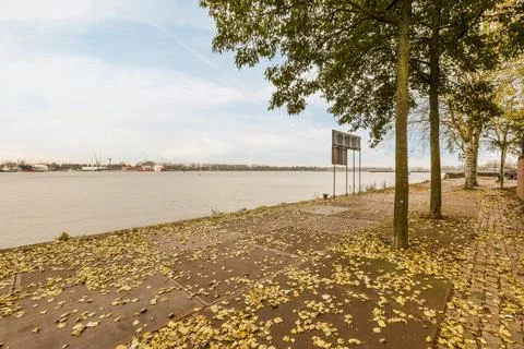 A view of a river with trees and a sign Stock Photos