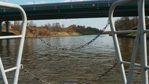 View of river water and its shores from boat approching a bridge over river Stock Footage 153993912