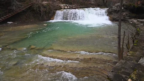 View of the river with a waterfall and rapids with blue water Stock Footage 303645641