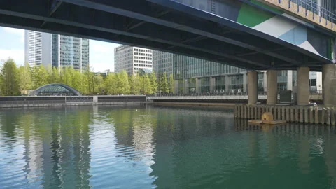A view of riverside with office buildings from underneath a bridge. Stock Footage 156466392