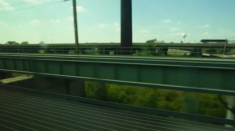 View of road and greenery from moving train. Stock Footage 67381400