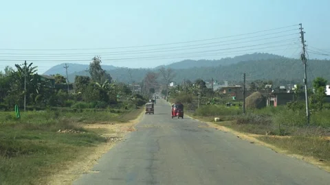 View of a road with auto-rickshaws and hills in Surkhet, Nepal. Video stock 335468302