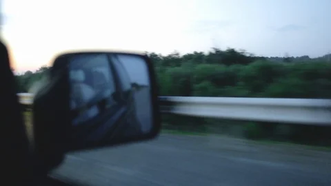 View of the road in the rear view mirror of the car in the morning Stock Footage 101011059