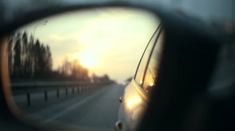 View of the road in the rearview mirror at sunset Stock Footage 48655574