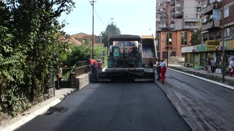 View from the road roller.Dolly shot.Forward and back.Workers filling the hole. Stock Footage 41487813