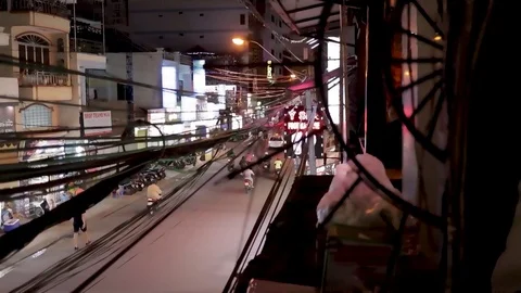 View of the road through electric wires, the road passing cars and motorbikes Stock Footage 124914698