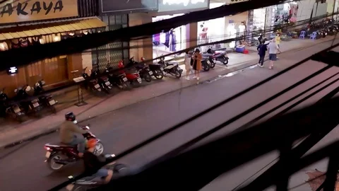 View of the road through electric wires, the road passing cars and motorbikes Stock Footage 124914723