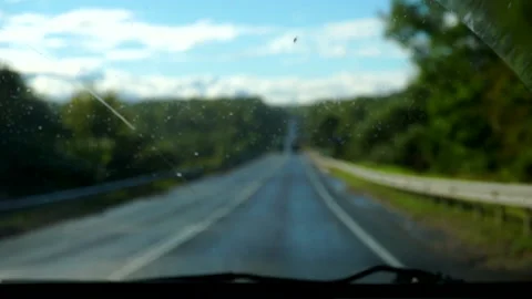 View of the road through the front window of a car.driving on a rainy day Stock Footage 139016220