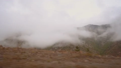 View of road through windshield of car Mountains and overcast sky. Stock Footage 218378305