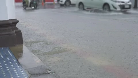 View on the road while heavy raining with flooding all over the asphast roa.. Видео 338023059
