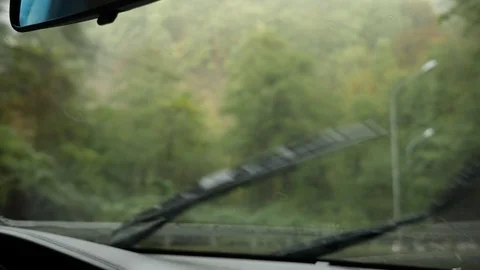 View of the road from the windshield of the car in the rain. Drops of water fall Video stock 82290898