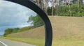 View of the roadside from car passenger seat. Person looking in side view mirror HD Footage