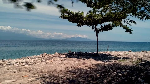View of roadside sea from the window of moving car slomo Stock Footage 125842861