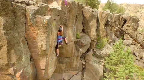 View of Rock Climber on Mountain with Gorgeous View by Aerial Drone Stock Footage 65765731