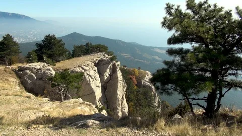 View of rock hanging over precipice of Mount Ai-Petri. Video stock 106607845