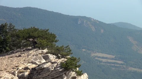 View of rock hanging over precipice. Pines on rocks of Ai Petri mountain. Stock Footage 106607849